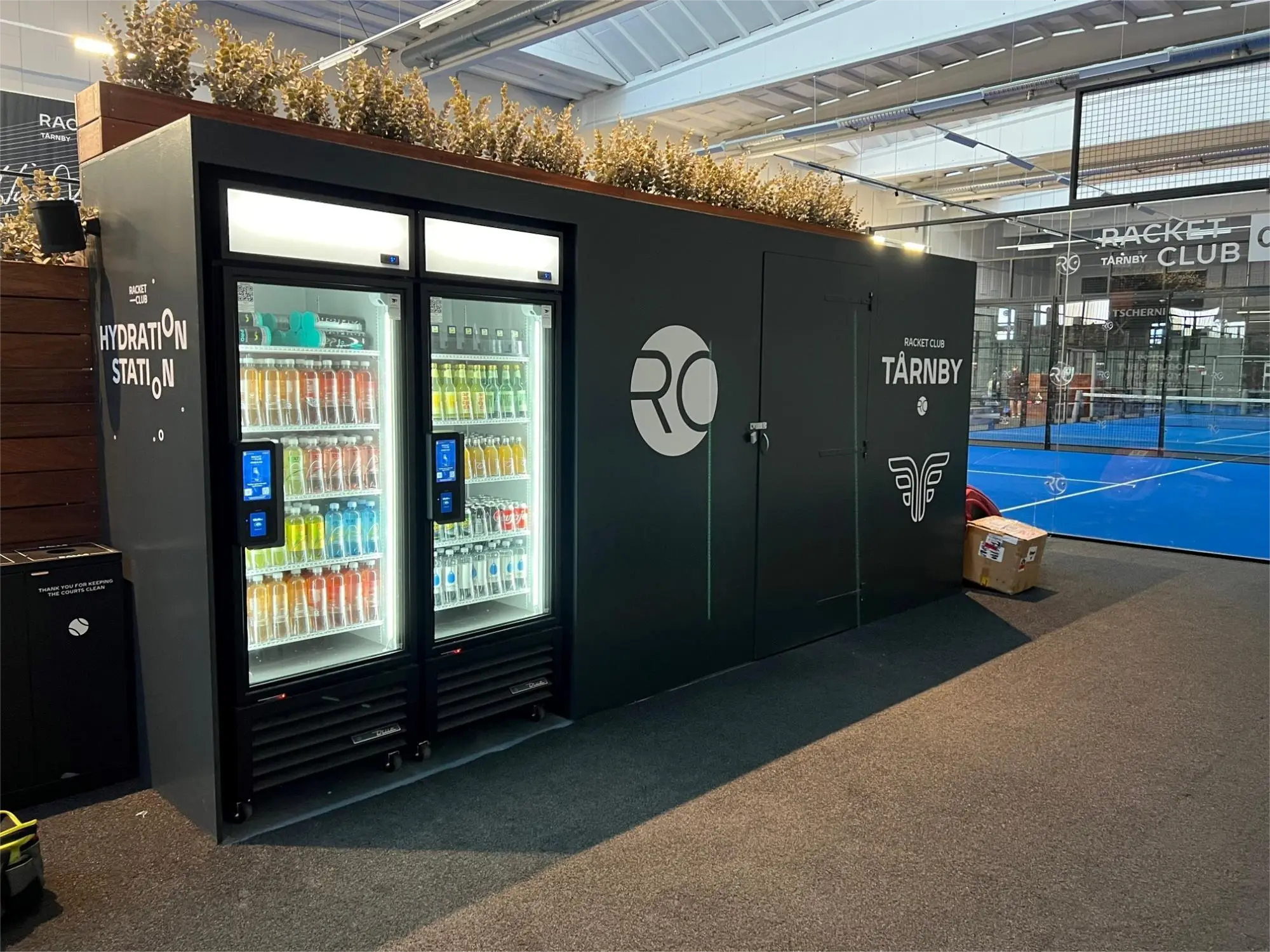 Premium smart coolers installation at Racket Club with modern branding and professional setup